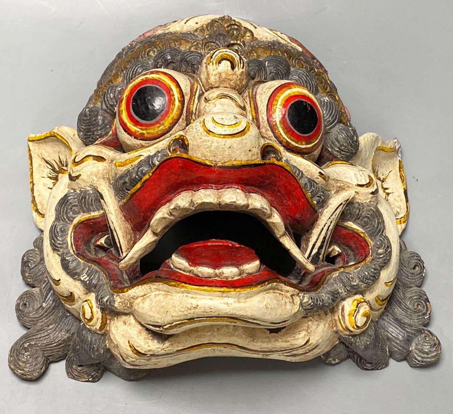 A Balinese carved and painted wood dragon mask, 28cm